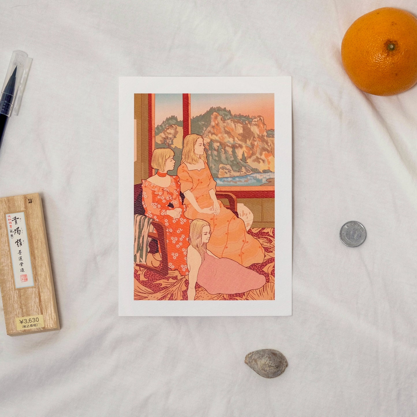 Vintage-style illustration of three women in a room with a scenic painting, placed on a light surface with an orange and pen.